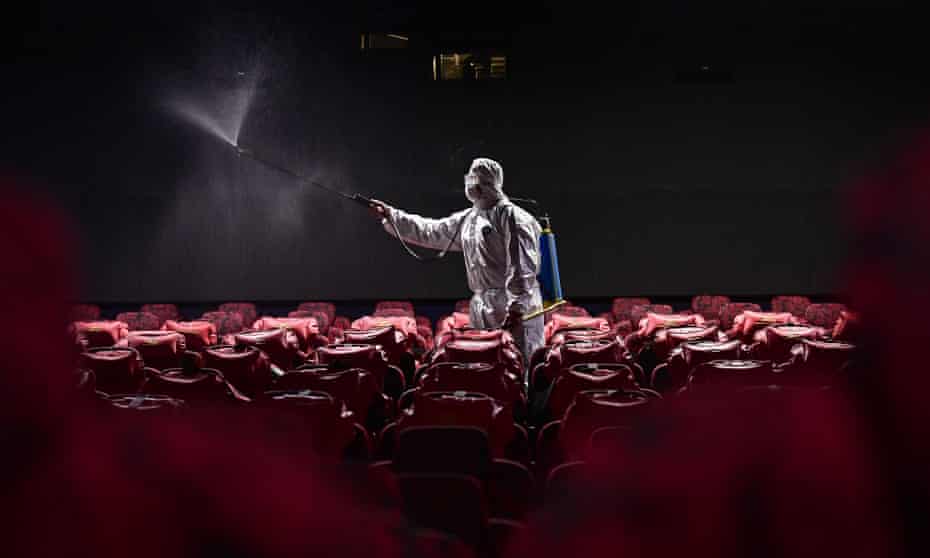 A staff member sprays disinfectant at a Shenyang cinema on 25 March.