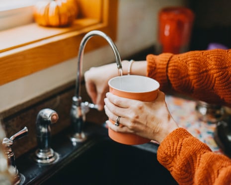Filling a mug with water from faucet