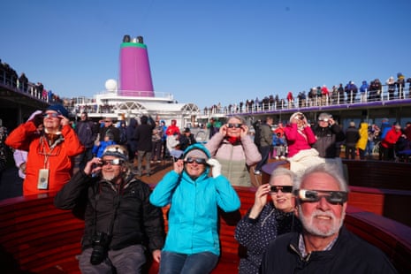 Passengers on board the Ambassador cruise ship Ambition watching the start of the total solar eclipse off the coast of Greenland.