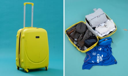 A yellow suitcase with clothes inside.