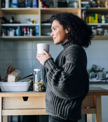 A Woman Drinking Hot Tea in the Kitchen