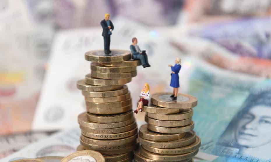 Models of men and women on a pile of coins and bank notes