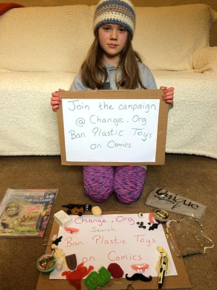 Skye Neville holds a placard reading: ‘Join the campaign @ change.org Ban Plastic Toys on Comics’