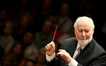 Williams holding a conductor's baton