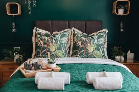 Stylish hotel bed with plush pillows and towels