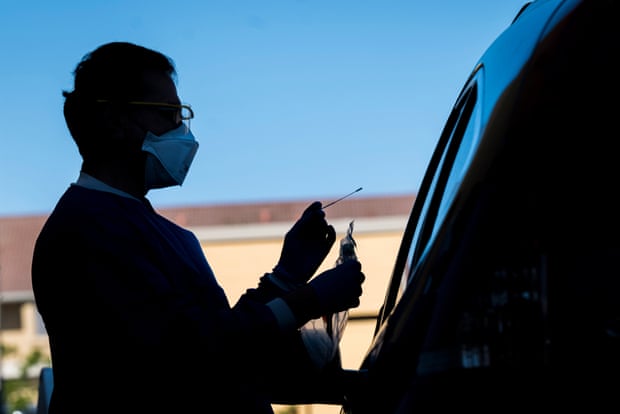 A healthcare worker administers a swab test at a Covid-19 drive-thru testing site in San Pablo, California, on 28 April.