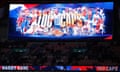 A screen at Wembley shows an image celebrating Harry Kane's 100 caps