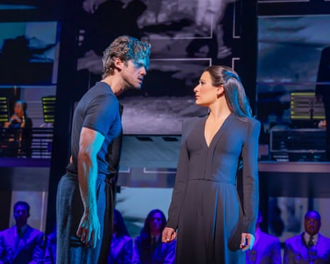 man and woman face each other on stage