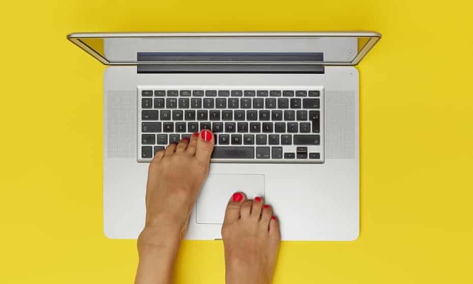 Photograph of feet on laptop