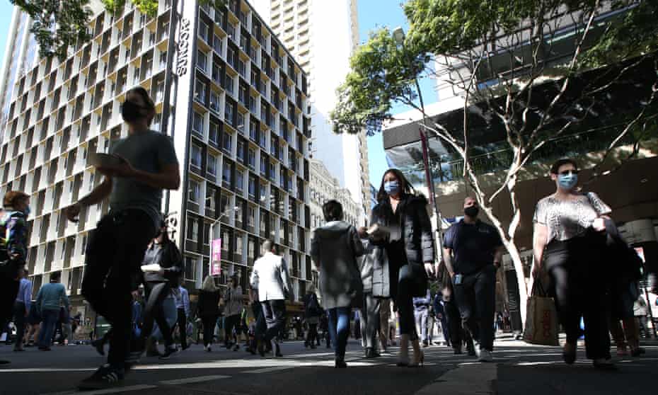 People walk through the Brisbane CBD