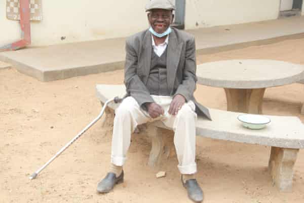 Domingo Zakani sits in a courtyard at Soda in Harare. He has lived in the home for five years.