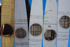 Canoes used for fishing in summer hanging upside down.