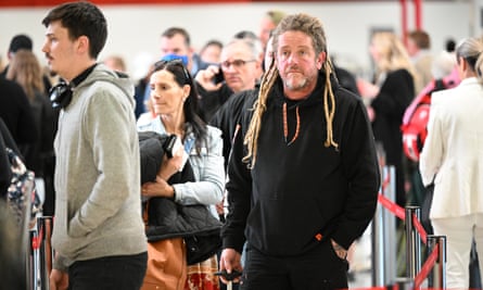 People are seen in line at the Qantas domestic arrivals terminal at Melbourne International Airport in Melbourne, Tuesday, October 11, 2022.