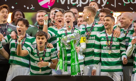 Celtic’s Callum McGregor lifts the League Cup after their victory over Rangers.