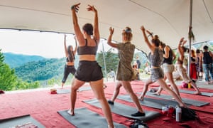 People do yoga at Meadows in the Mountains festival