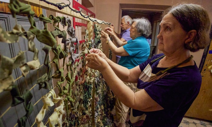 Ukrainian volunteers make a camouflage net for the army in Kharkiv, Ukraine.