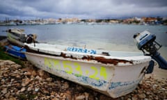 A discarded migrant vessel marked with the date on which it arrived on a beach in Lampedusa.
