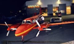 Red aircraft at night on the tarmac