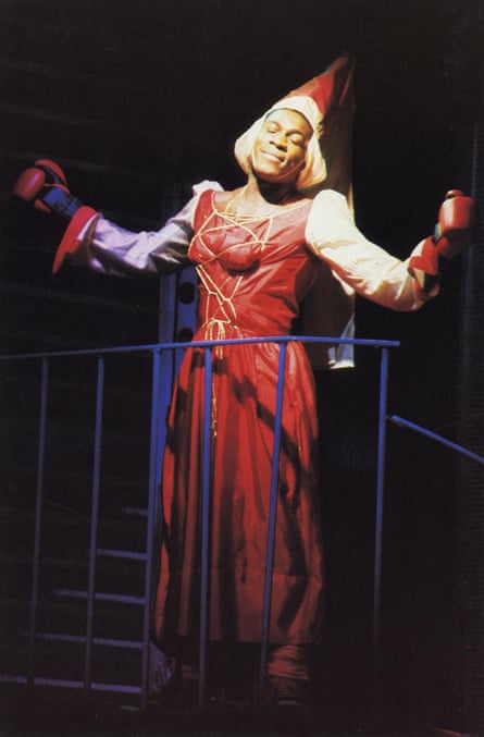 Frank Bruno in a medieval dress and hat, wearing boxing gloves