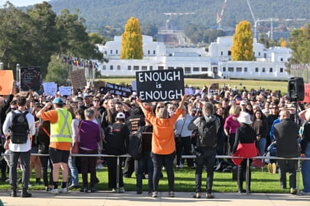 Protesters carry signs at a rally to a call for action to end violence against women, in front of Parliament House in Canberra, Sunday, 28 April 2024.