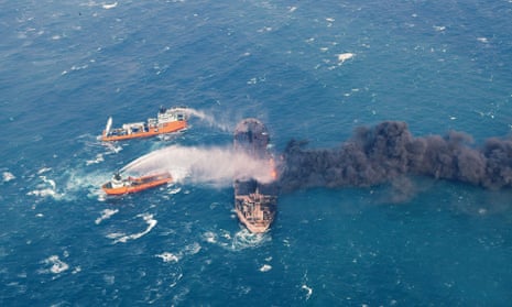 Firefighting boats work to put on the blaze on the oil tanker Sanchi
