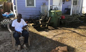 Joseph Cobbs sits in his friend’s yard, manning the generator for the block in Wilmington’s Northside. ‘All the white people around us got power. We got none.’