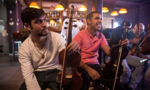 Two musicians from the Firqat Alnoor orchestra, which plays an eastern repertoire, take a break during rehearsals in Tel Aviv.
