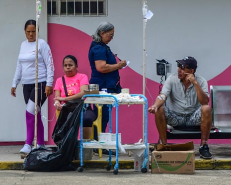 A nurse administers IV drips to people.