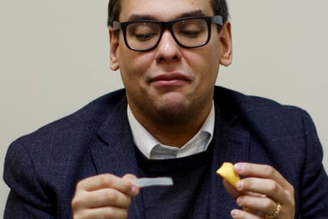  Representative George Santos (R-NY) reads a fortune cookie after lunch at his district office in Douglaston, New York, on 22 February.