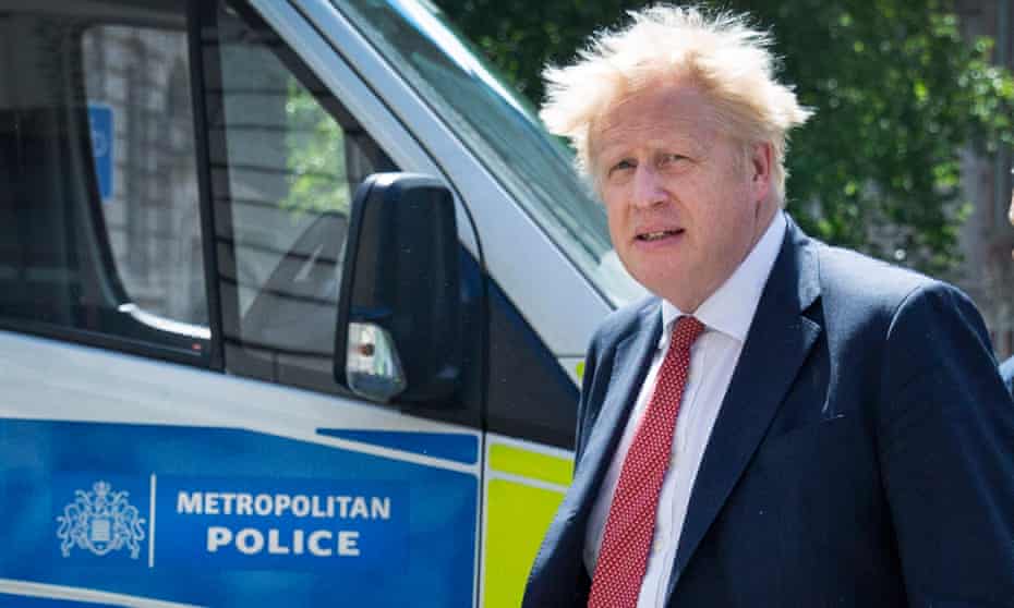 Boris Johnson in front of a Metropolitan police van