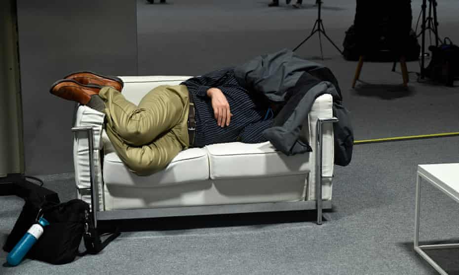 A delegate gets some sleep at COP25 in Madrid.