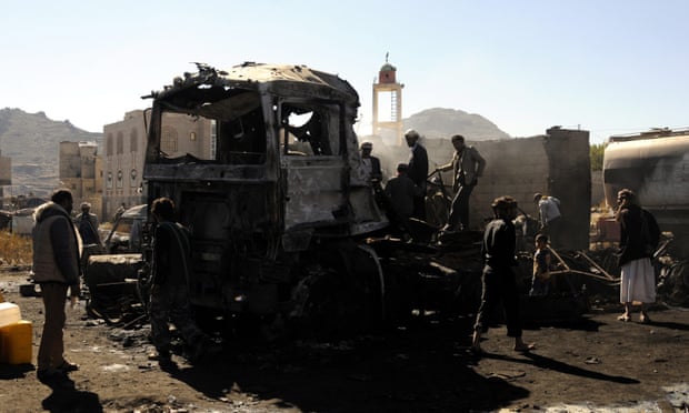 Yemenis inspect the site of alleged Saudi-led airstrikes that hit vehicles carrying food items, killing at least 11 people, in the central province of Ibb, Yemen Tuesday.