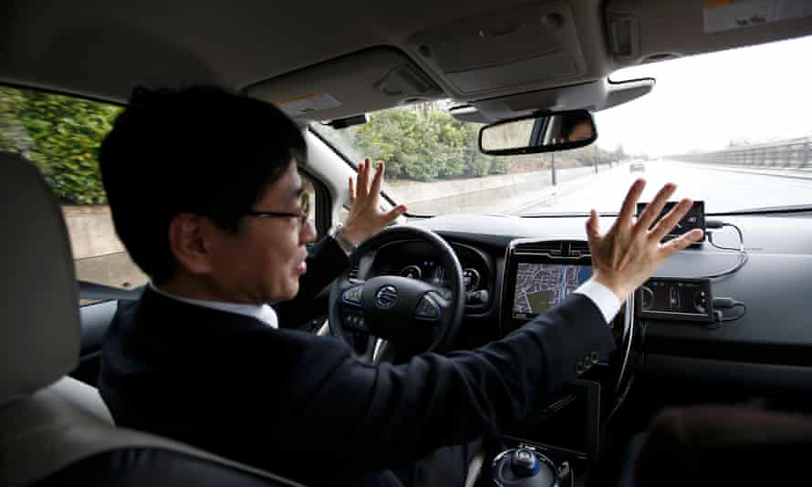 Nissan’s head of automated driving, Tetsuya Lijima, sits at the controls of a modified Nissan Leaf during its first demonstration on public roads in Europe, in London. c