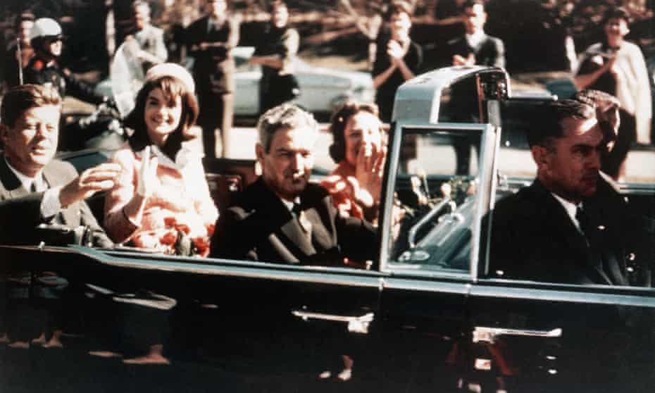President John F Kennedy, First Lady Jacqueline Kennedy, and the Texas governor, John Connally, ride through the streets of Dallas.