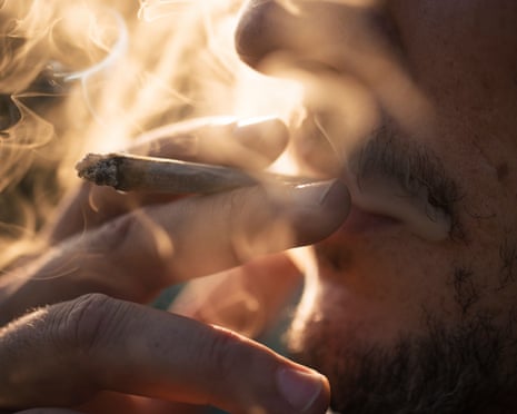 Close-up of person smoking a joint