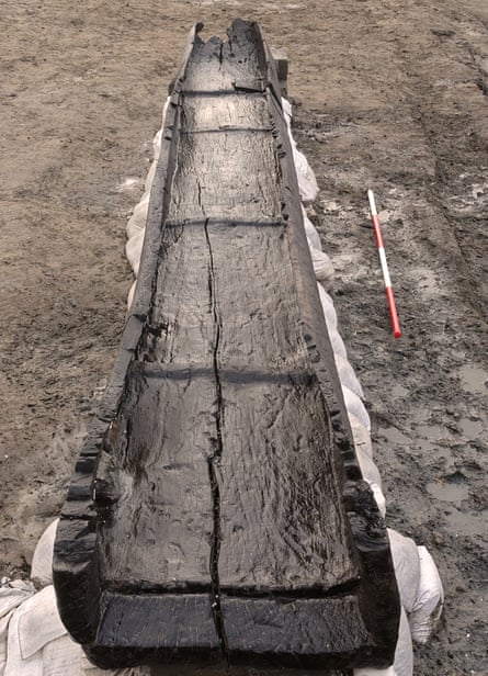a long ancient log boat lying on sand