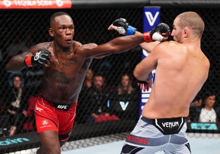 Nigerian-born New Zealander Israel Adesanya throws a punch at Sean Strickland during their UFC middleweight championship fight.