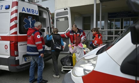Medical workers load children and equipment into an ambulance during the evacuation of a children’s hospital in Kyiv on Friday
