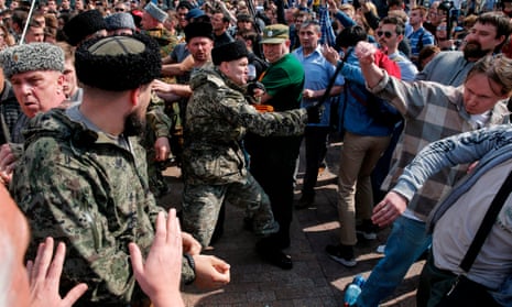 Cossacks scuffle with opposition supporters during an anti-Putin rally in Moscow on 5 May