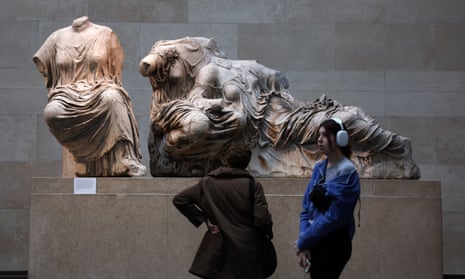 Visitors look at the Parthenon marbles in the British Museum in London.