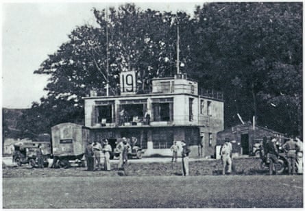 The control tower surrounded by military personnel when it was an allied base.