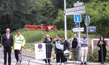 People wait next to the entrance of Mont Valerien cemetery, where Nahel Merzouk will be laid to rest, in Nanterre, near Paris, France, 01 July 2023.