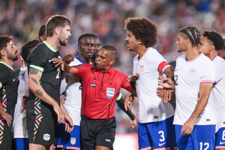Referee Kwinsi Williams separates Cameron Burgess and Chris Richards as things get heated.