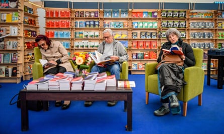 Festival-goers read in a bookshop at Cheltenham literature festival, one of Britain’s “big three” literary events.