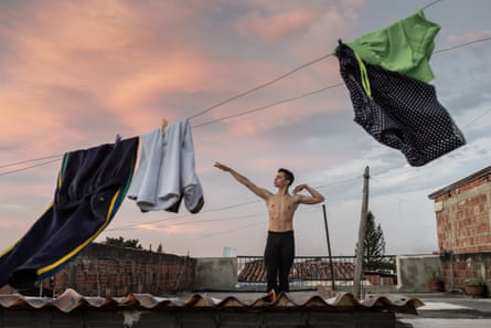 Josue Gomez in front of washing on a line