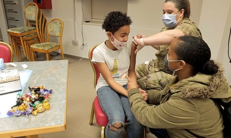 A child receives a dose of Covid-19 vaccine at the US Camp Darby military base near Pisa, Italy, on Monday.