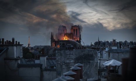 Flames and smoke are seen billowing from the roof at Notre Dame Cathedral.