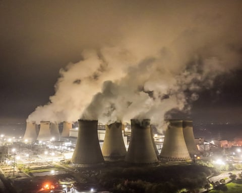 The cooling towers of Drax biomass power station produce steam during the night
