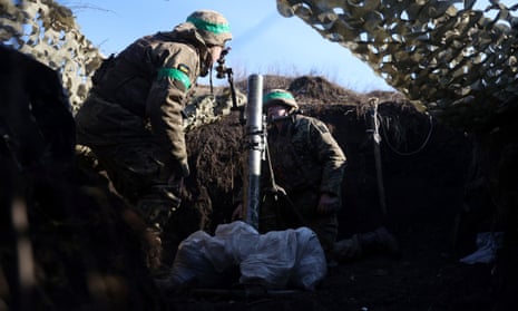 A Ukrainian serviceman gets ready to fire a mortar from a position not far from Bakhmut, Donetsk region