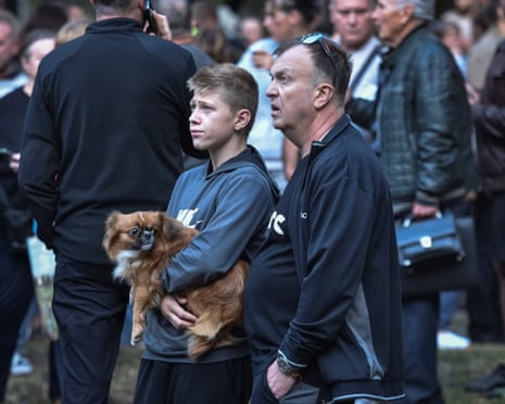 Residents react as they stand near a residential building damaged during a Russian missile strike in Dnipro, Ukraine on 20 September 2025.